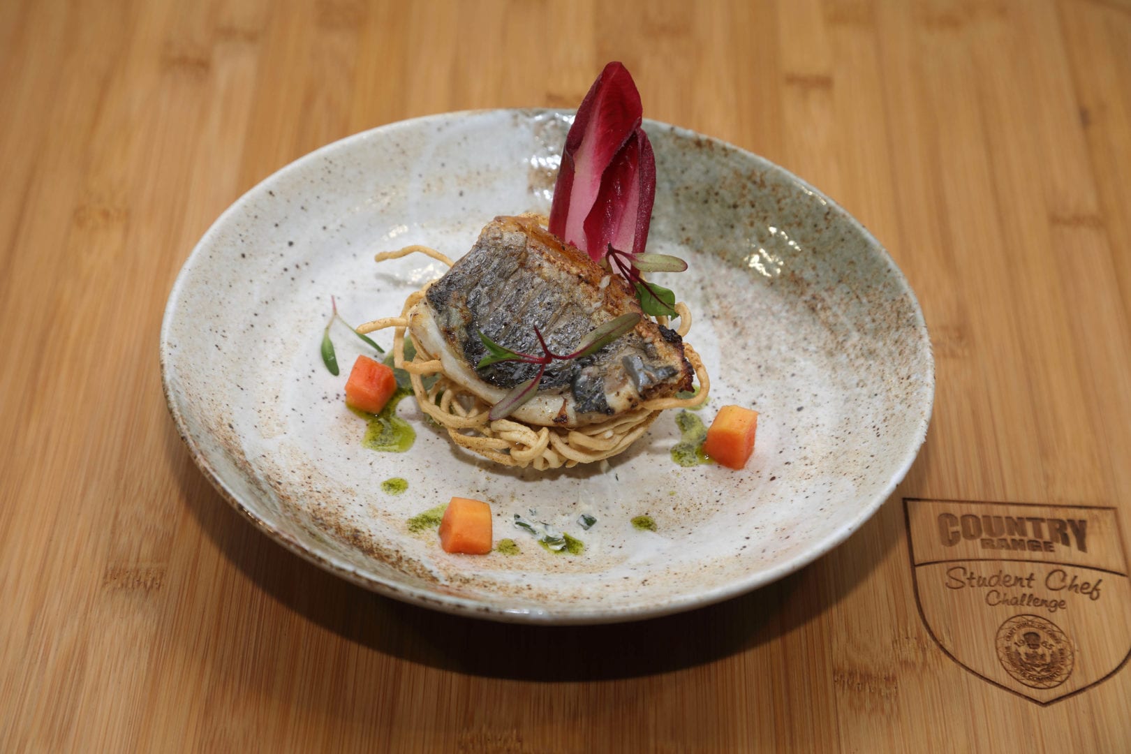 Asian spiced marinated sea bass, crisp cumin noodles, pickled chard, mint and goat’s cheese curd - C
